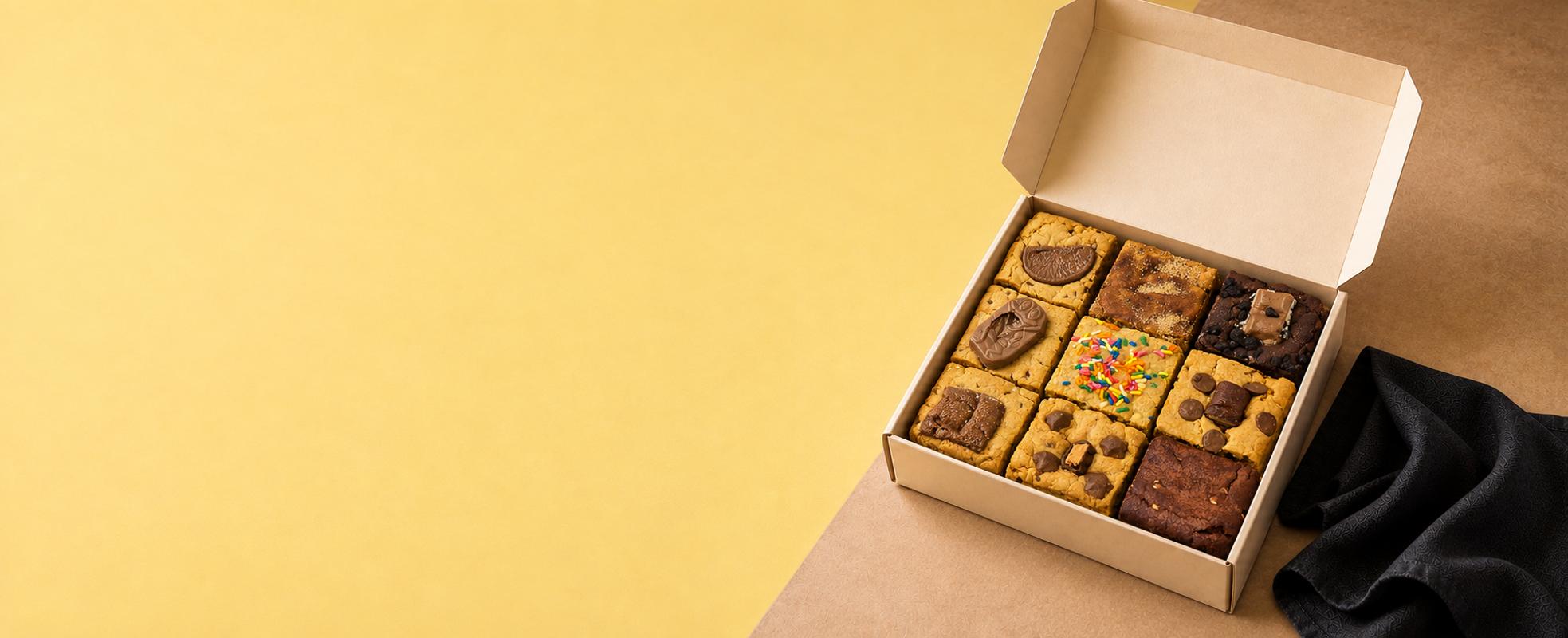 A gift box of nine Clever Cookie slices with chocolate and sprinkle toppings